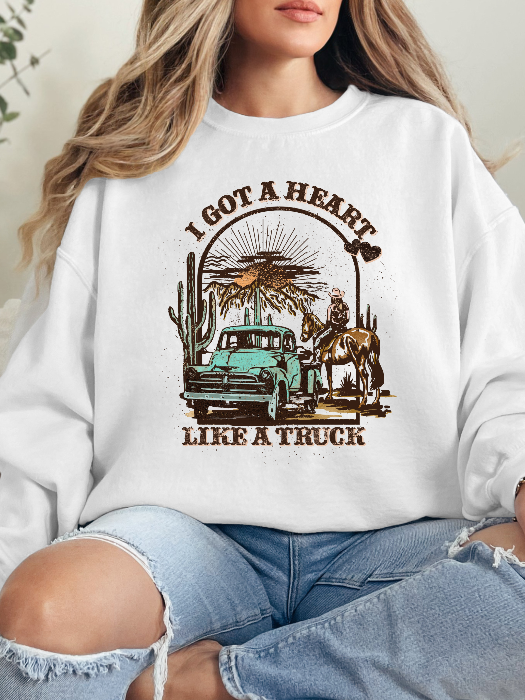 Heart Like A Truck Graphic Tee featuring an exclusive Willow Boutique country-inspired design on soft 100% cotton, perfect for country concerts, rodeos, Nashville trips, and everyday western style. Crewneck in white