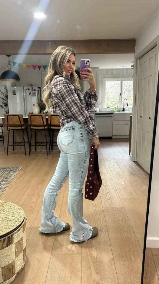 Keep Up Flare Acid Wash Jeans featuring Willow Boutique's exclusive V-Cross waistband, high-rise fit, mega stretch denim, frayed hem, and dramatic flare leg for a flattering boutique look.