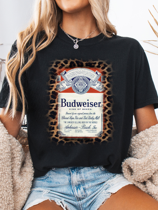 King of Beers Graphic Tee made from soft 100% cotton featuring a vintage-inspired beer graphic, perfect for tailgates, BBQs, brewery visits, country concerts, and casual everyday style. Color Black