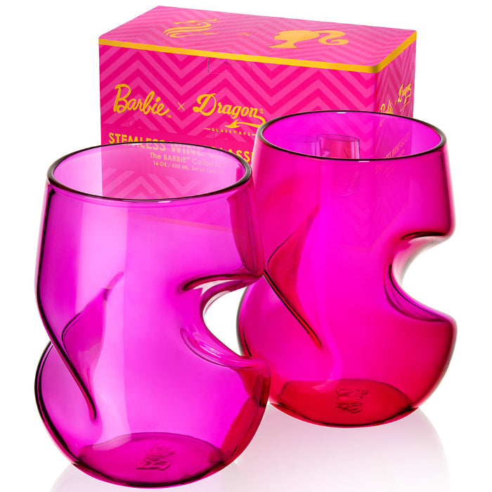 Two Barbie™ x Dragon Glassware® 16-ounce stemless wine glasses in pink and magenta with sculptural curved sides, displayed in front of a bright pink Barbie™ gift box.