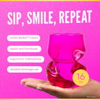 Two Barbie™ x Dragon Glassware® 16-ounce stemless wine glasses in pink and magenta with sculptural curved sides, displayed in front of a bright pink Barbie™ gift box.