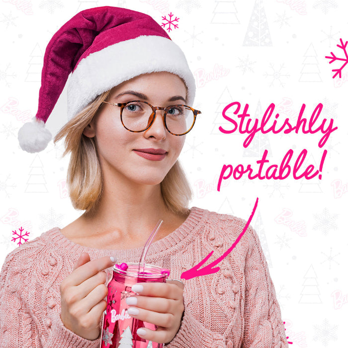 Set of two officially licensed Barbie™ Christmas 20 oz drinking glasses by Dragon Glassware in pink and clear designs with holiday trees, snowflakes, lids, glass straws, and gift box.