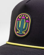 Cactus Black perforated rope golf hat by Pins & Aces featuring a cactus-inspired design, adjustable snapback, built-in magnetic ball marker holder, and matching golf ball marker.