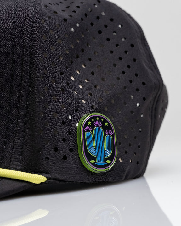 Cactus Black perforated rope golf hat by Pins & Aces featuring a cactus-inspired design, adjustable snapback, built-in magnetic ball marker holder, and matching golf ball marker.