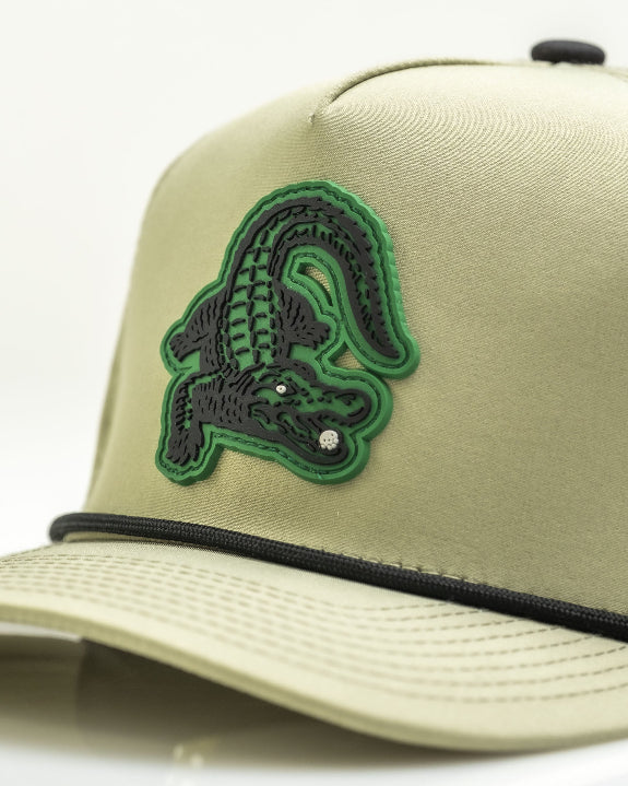Gator Olive perforated rope golf hat by Pins & Aces featuring an olive green design, breathable perforated panels, adjustable snapback, and built-in magnetic golf ball marker holder.