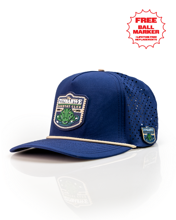 Zynbabwe Country Club Navy perforated rope golf hat by Pins & Aces with adjustable snapback, magnetic ball marker holder, and matching golf ball marker.