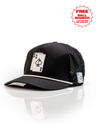 Ace/King Black perforated rope golf hat by Pins & Aces featuring a black poker-inspired design, braided rope accent, adjustable snapback, and built-in magnetic ball marker holder.