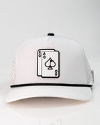 Ace/King White perforated rope golf hat by Pins & Aces with an adjustable snapback, built-in magnetic ball marker holder, and matching golf ball marker.