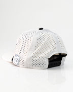 Ace/King White perforated rope golf hat by Pins & Aces with an adjustable snapback, built-in magnetic ball marker holder, and matching golf ball marker.
