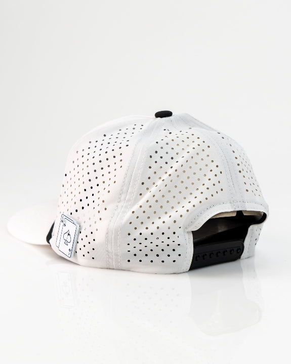 Ace/King White perforated rope golf hat by Pins & Aces with an adjustable snapback, built-in magnetic ball marker holder, and matching golf ball marker.