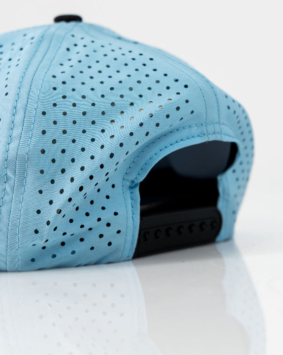 Baby blue Pins & Aces perforated rope golf hat featuring a middle finger design, breathable perforated panels, adjustable snapback, and built-in magnetic golf ball marker holder.