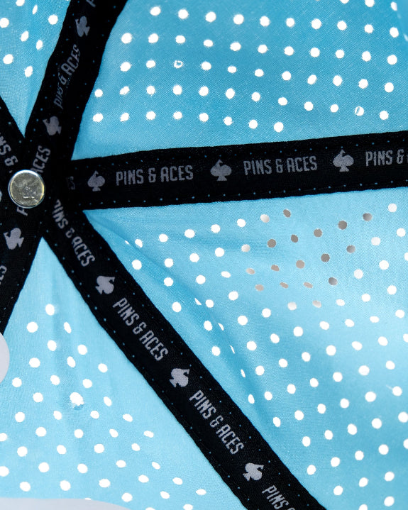 Baby blue Pins & Aces perforated rope golf hat featuring a middle finger design, breathable perforated panels, adjustable snapback, and built-in magnetic golf ball marker holder.