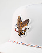 Freedom Eagle White perforated rope golf hat by Pins & Aces featuring a patriotic eagle design, adjustable snapback, magnetic ball marker holder, and matching golf ball marker.