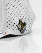 Freedom Eagle White perforated rope golf hat by Pins & Aces featuring a patriotic eagle design, adjustable snapback, magnetic ball marker holder, and matching golf ball marker.