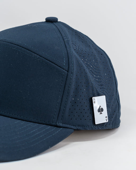 Tradesman Navy golf hat by Pins & Aces featuring a tonal embroidered spade logo, structured 6-panel design, perforated side panels, curved bill, and adjustable snapback.