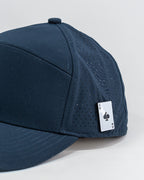 Tradesman Navy golf hat by Pins & Aces featuring a tonal embroidered spade logo, structured 6-panel design, perforated side panels, curved bill, and adjustable snapback.