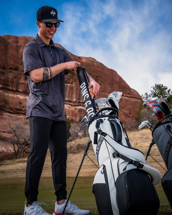 Black Pins & Aces insulated golf beer sleeve designed to hold up to seven cans and slide inside most standard golf bags.