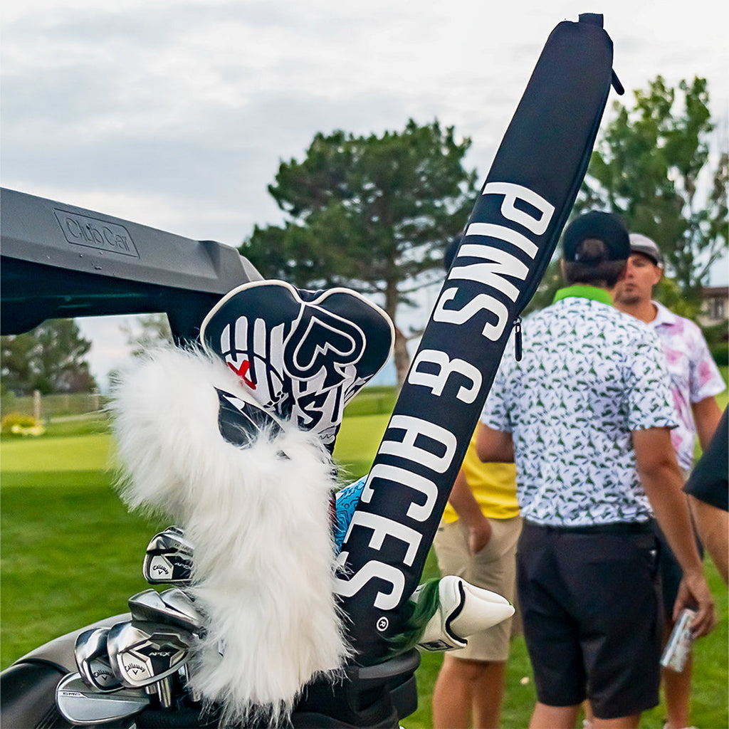 Black Pins & Aces insulated golf beer sleeve designed to hold up to seven cans and slide inside most standard golf bags.