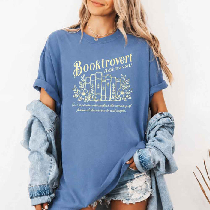 Booktrovert Comfort Colors T-shirt featuring a playful book lover graphic on a relaxed garment-dyed 100% cotton tee for readers and bookworms in color Blue Jean