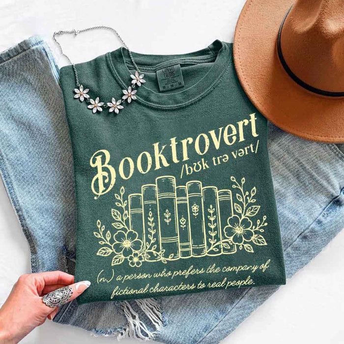 Booktrovert Comfort Colors T-shirt featuring a playful book lover graphic on a relaxed garment-dyed 100% cotton tee for readers and bookworms in color Blue Spruce