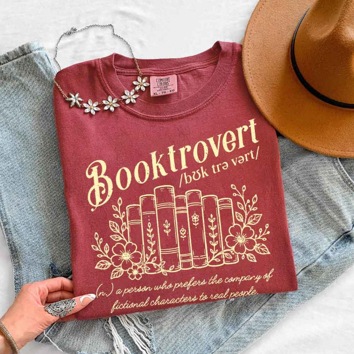 Booktrovert Comfort Colors T-shirt featuring a playful book lover graphic on a relaxed garment-dyed 100% cotton tee for readers and bookworms in color Crimson
