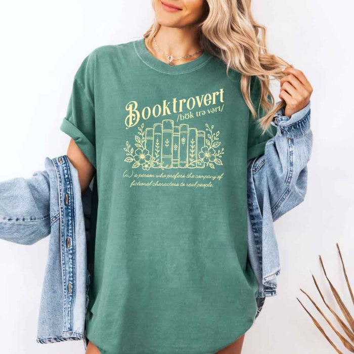 Booktrovert Comfort Colors T-shirt featuring a playful book lover graphic on a relaxed garment-dyed 100% cotton tee for readers and bookworms in color Light Green