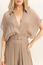 Women’s two-piece set featuring a cropped collared wrap top with soft pleating and coordinating flowy wide-leg pants in a lightweight cotton-rayon blend.