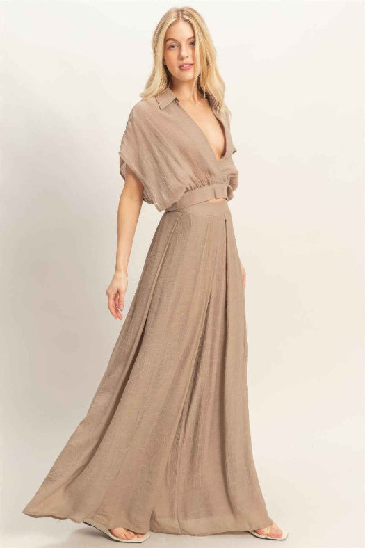 Women’s two-piece set featuring a cropped collared wrap top with soft pleating and coordinating flowy wide-leg pants in a lightweight cotton-rayon blend.