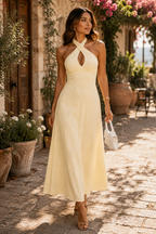 Audrey is wearing a Yellow Halter Cross Neck Backless Maxi Dress | Elegant Cotton Long Dress