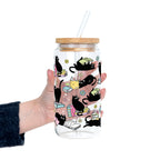 Black Cats on Books drinkware design featuring whimsical black cats lounging on colorful stacks of books with pastel flowers and bookish details.