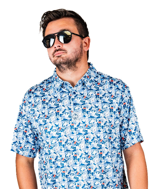 Men’s Coca-Cola golf polo from the official Coca-Cola x Pins & Aces collaboration featuring a blue and white all-over print with red accents and an athletic performance fit.