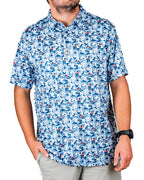 Men’s Coca-Cola golf polo from the official Coca-Cola x Pins & Aces collaboration featuring a blue and white all-over print with red accents and an athletic performance fit.