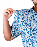 Men’s Coca-Cola golf polo from the official Coca-Cola x Pins & Aces collaboration featuring a blue and white all-over print with red accents and an athletic performance fit.