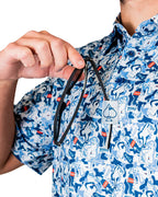 Men’s Coca-Cola golf polo from the official Coca-Cola x Pins & Aces collaboration featuring a blue and white all-over print with red accents and an athletic performance fit.