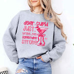 Dear Cupid Something Strong Valentine’s Day crewneck sweatshirt featuring a funny Cupid-inspired graphic on a cozy relaxed-fit unisex sweatshirt in Grey