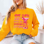 Dear Cupid Something Strong Valentine’s Day crewneck sweatshirt featuring a funny Cupid-inspired graphic on a cozy relaxed-fit unisex sweatshirt in Gold
