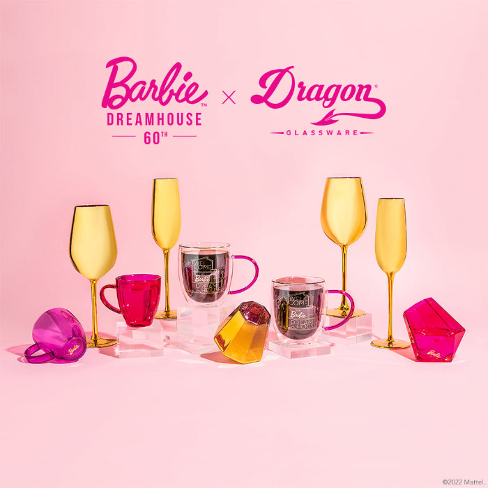 Set of two Barbie™ x Dragon Glassware® Dreamhouse™ 17.5 oz stemmed wine glasses with metallic gold exteriors, pink interiors, Barbie™ logo bases, and pink gift box.