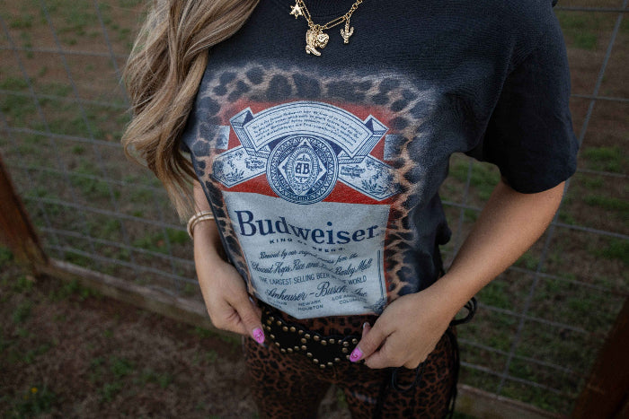 King of Beers Graphic Tee made from soft 100% cotton featuring a vintage-inspired beer graphic, perfect for tailgates, BBQs, brewery visits, country concerts, and casual everyday style. Color Black