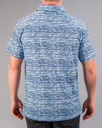Men’s Fragment Blue golf polo by Pins & Aces featuring an all-over abstract fragmented line pattern in blue and white with short sleeves and an athletic performance fit.