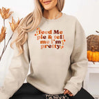 Feed Me Pie and Tell Me I’m Pretty funny Thanksgiving sweatshirt featuring a fall pie lover graphic on a cozy unisex crewneck in Sand