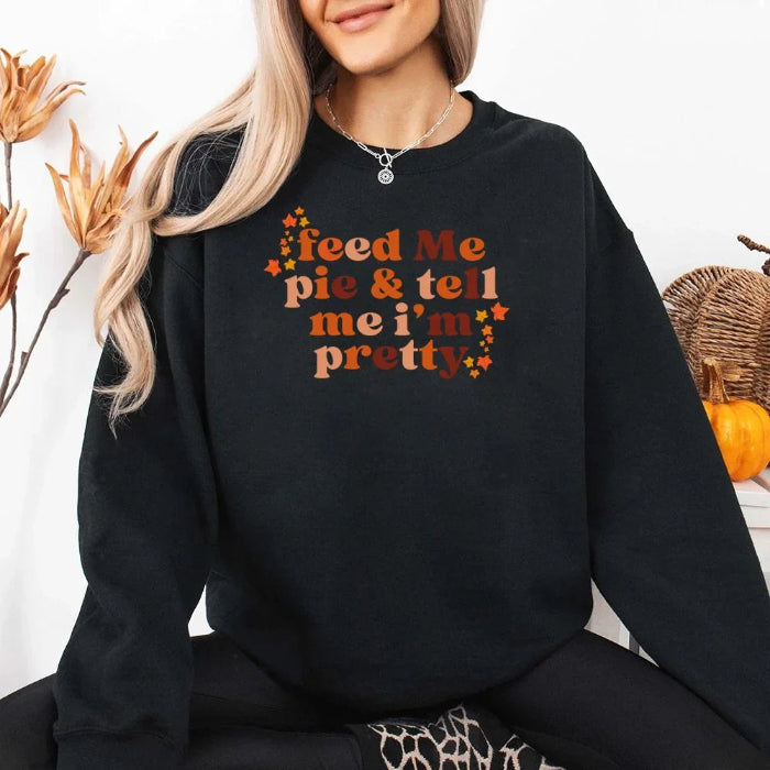 Feed Me Pie and Tell Me I’m Pretty funny Thanksgiving sweatshirt featuring a fall pie lover graphic on a cozy unisex crewneck in Black