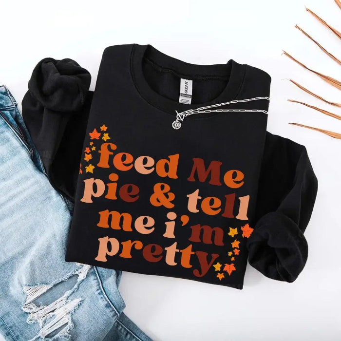 Feed Me Pie and Tell Me I’m Pretty funny Thanksgiving sweatshirt featuring a fall pie lover graphic on a cozy unisex crewneck in Black