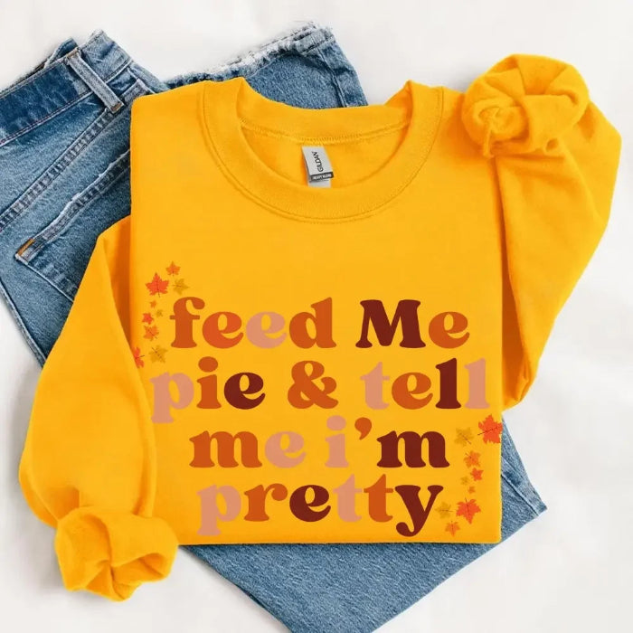 Feed Me Pie and Tell Me I’m Pretty funny Thanksgiving sweatshirt featuring a fall pie lover graphic on a cozy unisex crewneck in Gold