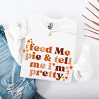 Feed Me Pie and Tell Me I’m Pretty funny Thanksgiving sweatshirt featuring a fall pie lover graphic on a cozy unisex crewneck in White