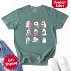 Ghost Reading Comfort Colors T-shirt featuring a whimsical ghost reading a book on a relaxed garment-dyed cotton Halloween graphic tee for book lovers in Light Green