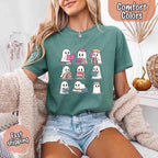 Ghost Reading Comfort Colors T-shirt featuring a whimsical ghost reading a book on a relaxed garment-dyed cotton Halloween graphic tee for book lovers in Light Green
