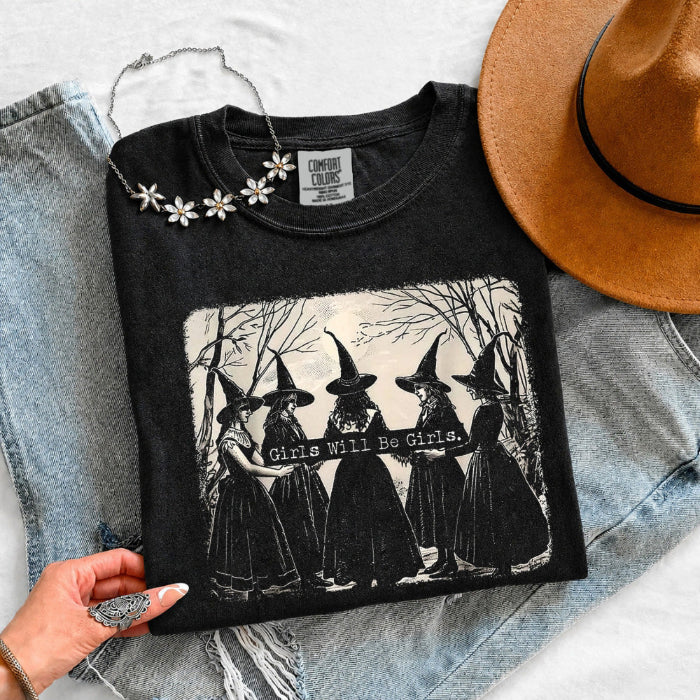 Girls Will Be Girls Comfort Colors graphic T-shirt with a playful Halloween-inspired design for spooky season in Black