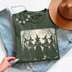 Girls Will Be Girls Comfort Colors graphic T-shirt with a playful Halloween-inspired design for spooky season in Moss