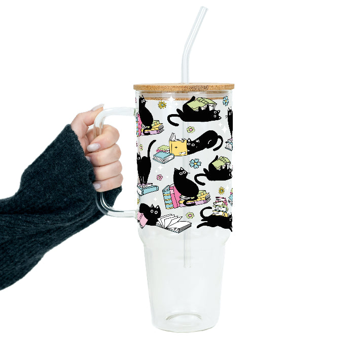 Black Cats on Books drinkware design featuring whimsical black cats lounging on colorful stacks of books with pastel flowers and bookish details.