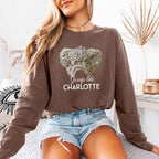 Gossip Like Charlotte Comfort Colors long sleeve shirt featuring a historical fiction and Regency-inspired literary graphic on a relaxed garment-dyed cotton tee in Espresso